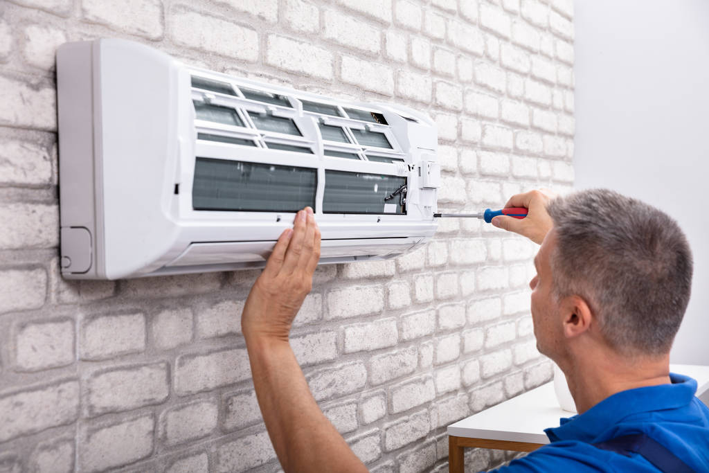 Technician Fixing Air Conditioner