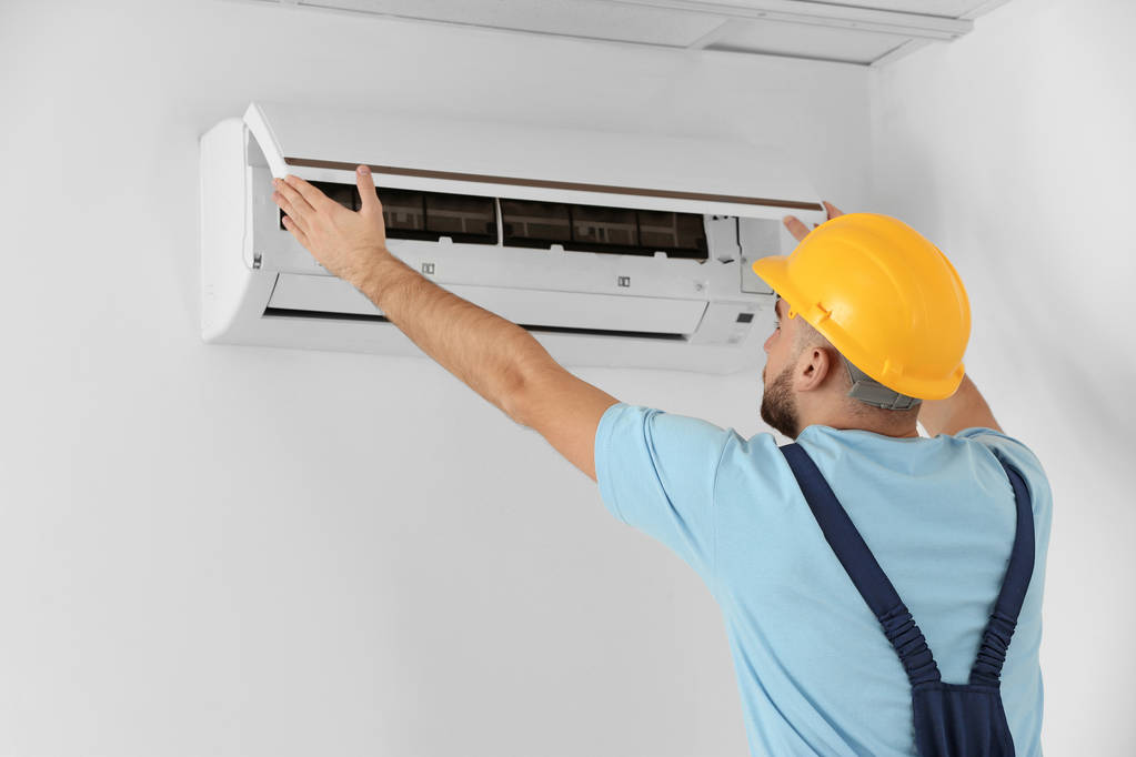 Technician Fixing Air Conditioner