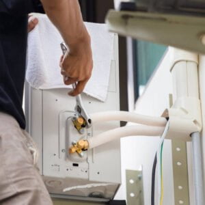 Technician Man Using Wrench Fixing Modern Air Conditioning System Maintenance